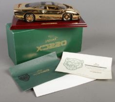 A boxed Gwilo 1/18th scale 22ct gold plated Jaguar XJ220.