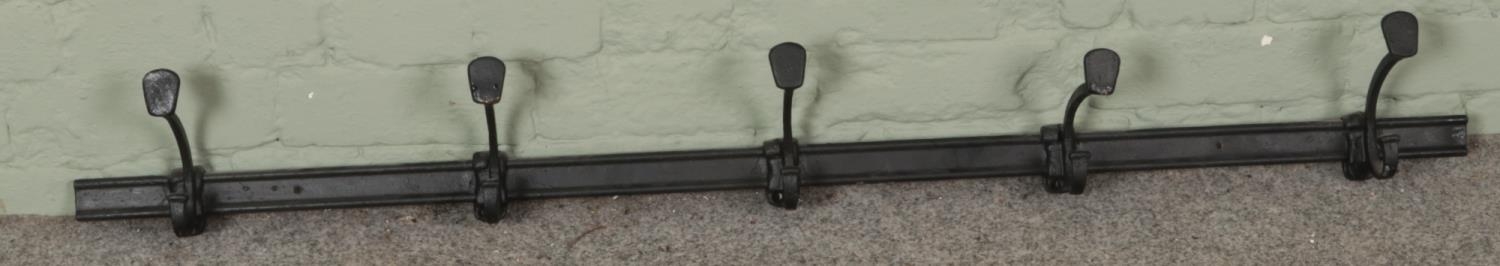 A painted cast iron five hook wall mounting coat rack. (128cm)