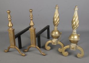 Two pairs of brass firedogs, one with conical swirl design. Tallest: 38cm.