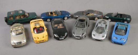 A large quantity of 1/18 scale model cars including a Maisto McLaren F1, The Beanstalk Group Aton