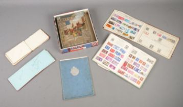 A collection of assorted ephemera, to include two partially filled stamp albums, autograph books