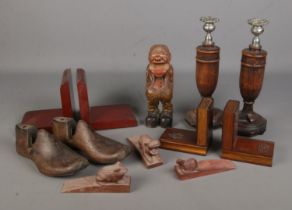 A collection of treen to include carved animal doorstops, two pairs of bookends, nutcracker, pair of