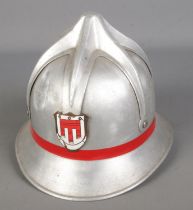 A metal fireman's helmet with enamel crest.