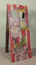 A vintage wooden fairground 'Aunt Sally' peep board depicting Punch & Judy. 151cm x 59cm.