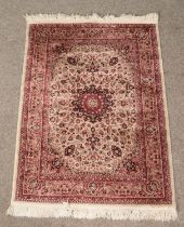 A small Isfahan Collection red ground rug with central medallion motif and floral decoration (