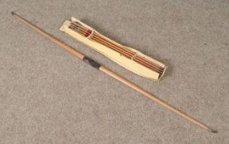 A late 19th century to early 20th century yew wood bow along with a box of arrows both produced by F