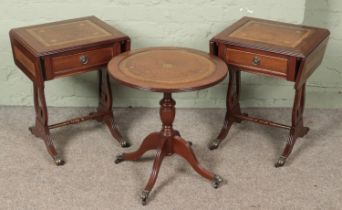 A pair of mahogany sofa tables with lyre supports and leather inset tops along with a matching