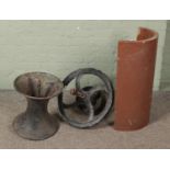 A cast iron diablo style pot together with cast iron wheel and half drainage pipe marked J Kitson