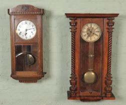 Two wall clocks. Includes carved mahogany 8 day example, etc. Carved mahogany wall clock in need