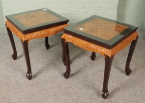 A pair of Oriental hardwood occasional tables. Having deep carved decoration to tops depicting