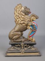 A painted cast iron door stop in the form of a lion rampant raised on plinth. Approx. height 36cm.