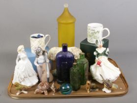 A quantity of ceramics and glass. Includes Royal Doulton figures, Nao, glass poison bottles,