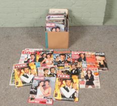 A box of James Bond related magazines.