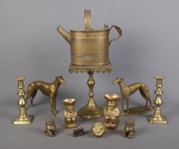 A collection of brasswares, to include two greyhounds, watering can, a pair of candlesticks and