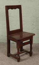 A small late 18th/early 19th century oak chair of jointed construction. Height of back 88cm. Signs