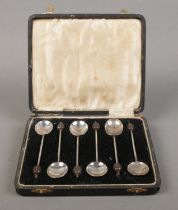 A cased set of six silver demitasse spoons with coffee bean finials. Assayed for Birmingham, 1933 by