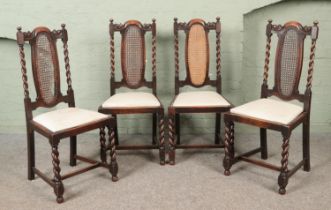 A set of four oak chairs with barley twist supports and bergere back panels. Damage to bergere on