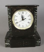 A Wm. Widdop black slate and marble mantle clock featuring roman numeral dial. Converted to quartz.