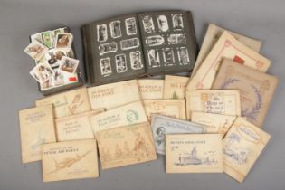 A large quantity of cigarette cards including several complete and incomplete players albums