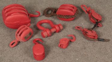 A quantity of painted pulleys. Includes three section block example, etc.