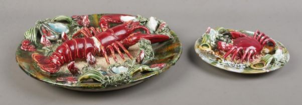 A Majolica style ceramic lobster plate, together with a similar smaller crab plaque. Diameter of