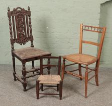 A heavily carved oak chair with fruit and vine design together with mahogany canework seated chair