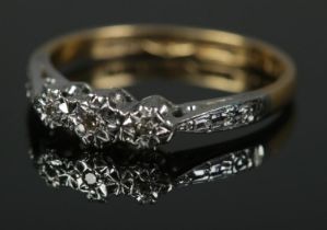 An 18ct gold, platinum ring set with three diamonds. Size J, 1.9g.