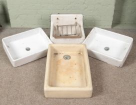 A collection of four ceramic Belfast sinks including Astracast example.