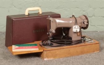 A cased Singer 185k sewing machine, with key and instruction manual.