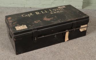 A military Royal Army Medical Core black painted tin trunk stenciled for Capt. R. Li. Lyon (R.A.M.C)