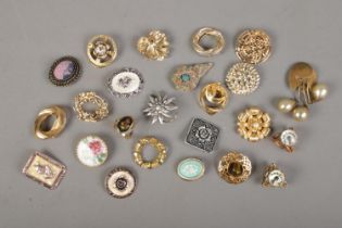 A large quantity of scarf clips and rings including floral and yellow metal examples.