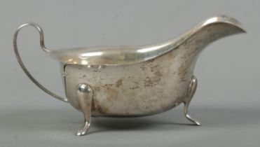 A George VI silver cream boat, raised on three feet. Assayed for Sheffield, 1939 by Viner's Ltd (