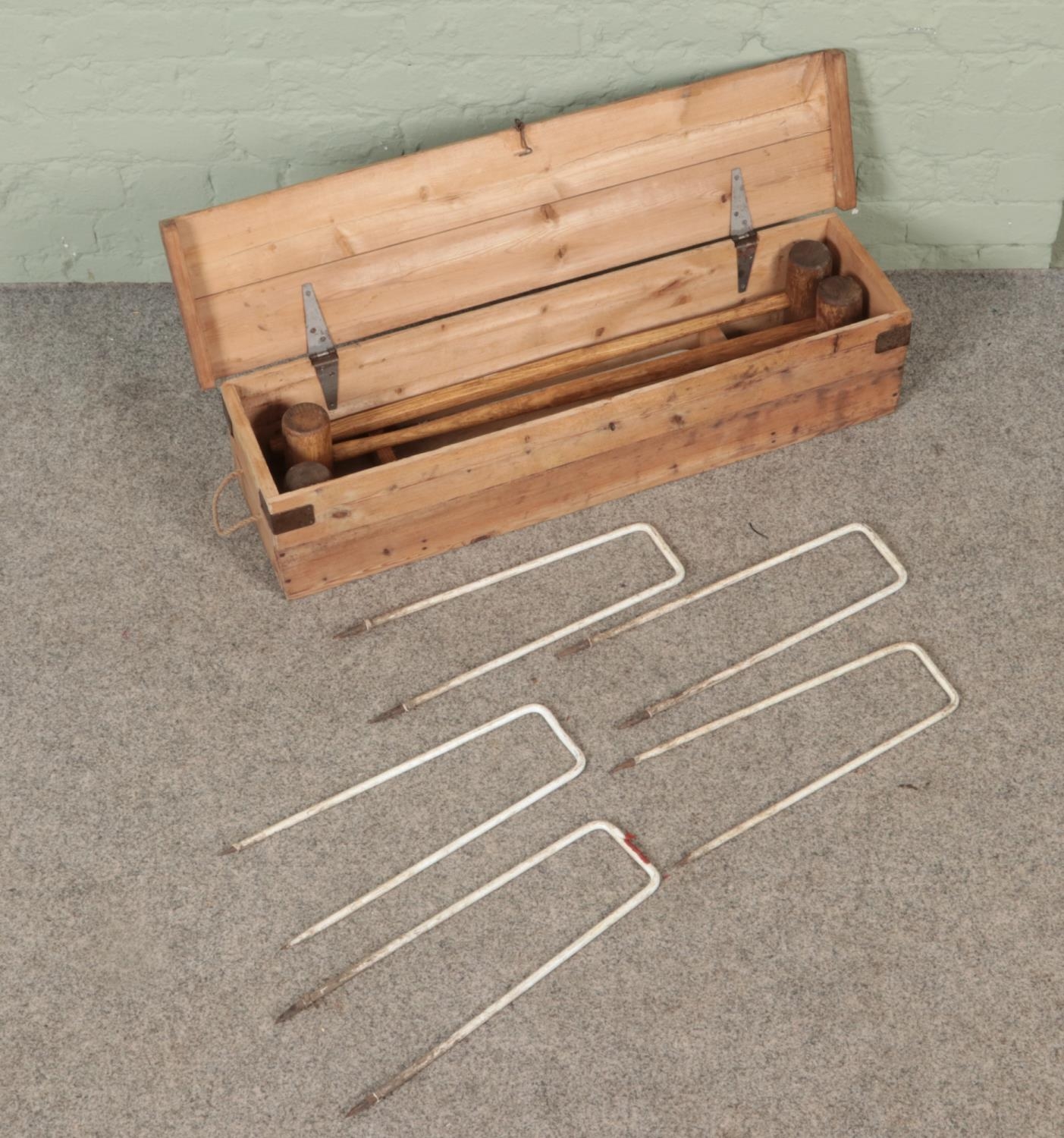 A vintage Croquet set with fitted wooden case. Missing balls.