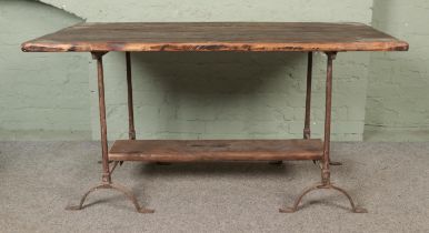 A chunky pine plank top trestle table with cast iron base. Hx77cm Wx153cm Dx77cm