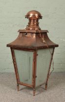 A copper lantern with etched glass panels. Height 90cm.