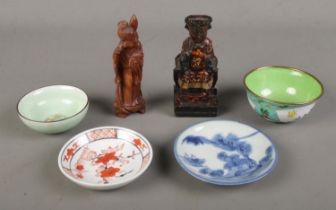 A collection of oriental wares including a wooden carved figure of a emperor, enamelled dish,
