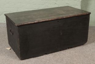 A 19th century pine blanket box with cast iron handles in interior candle box. Hx46cm Wx101cm Dx54cm