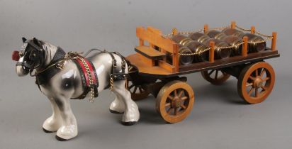 A ceramic shire horse with scratch built wooden cart.
