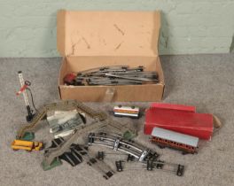A quantity of 0 gauge track and other accessories including diorama buildings and carriages.