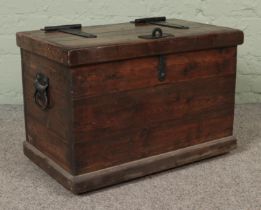 A pine trunk with hasp lock lid and cast iron handles. Hx44cm Wx64cm Dx37cm