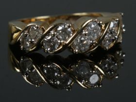 An 18ct Gold and ten stone diamond ring, with the stones set in a rope twist setting. Size K.