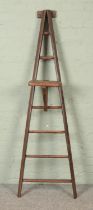 A seven rung wooden A-Frame ladder, possibly for fruit picking, with a platform step. Height: 191cm.