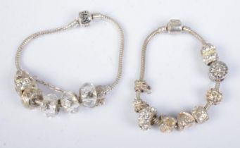 A Pandora charm bracelet featuring six charms along with one similar style bracelet.