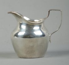 A Victorian silver cream jug. Assayed for London, 1897. Total weight: 74g. Makers mark indistinct.