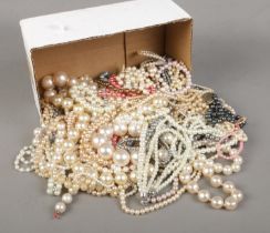 A box of simulated pearl necklaces and bracelets.