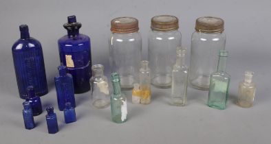 A collection of assorted glass bottles to include Bristol blue, poison and Kilner jar examples.