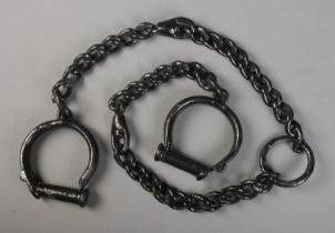 A set of 19th century cast iron shackles, 140cm long.