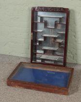 An oriental glazed display cabinet with mirrored back together with a table top glazed display