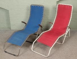 Two vintage metal framed deck chairs.