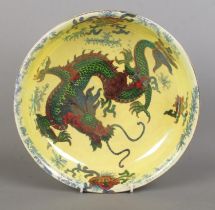 A Bursley Ware 'Dragon' ceramic bowl, decorated with central dragon motif, gilt highlights and